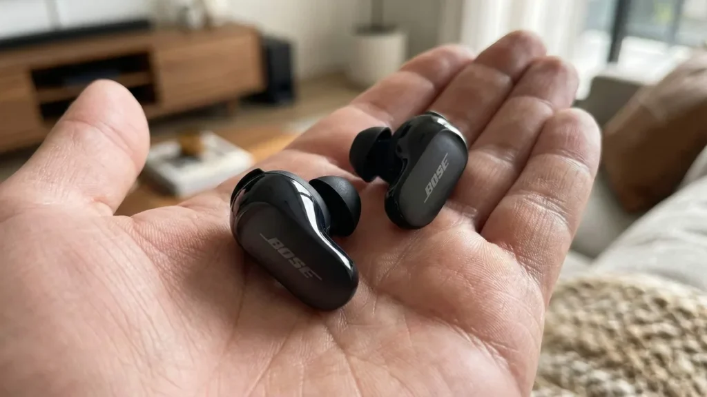 Bose QuietComfort Ultra earbuds resting on palm close-up review test