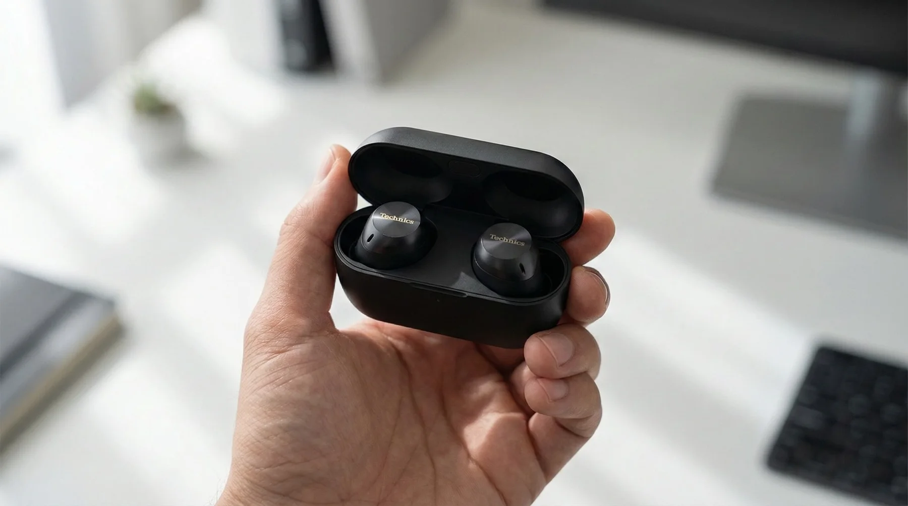 Technics EAH-AZ100 black wireless earbuds in hand